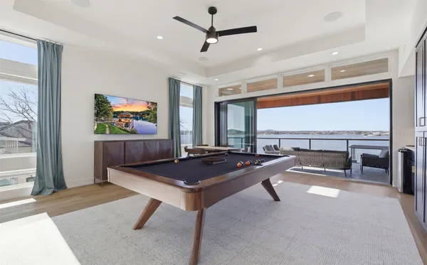a living room with projector furniture and a floor to ceiling window