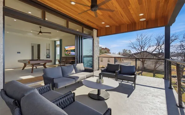 a living room with furniture a rug and a chandelier