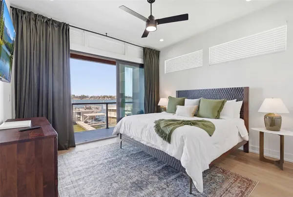 a large bed sitting in a bedroom next to a window