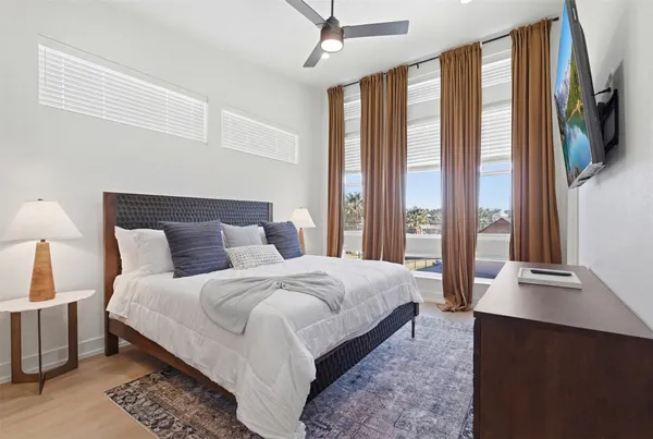 a bedroom with a large bed and a large window