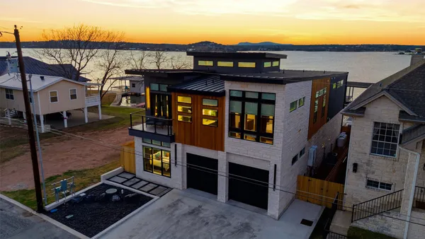 a roof deck with outdoor seating and lake view