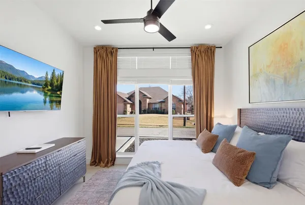 a bedroom with furniture and a flat screen tv