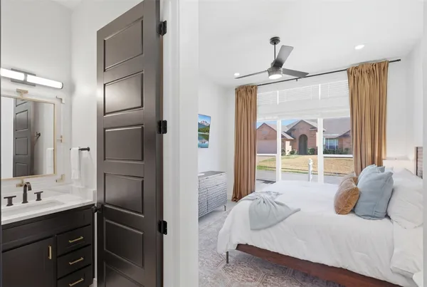 a bedroom with a bed and a large window