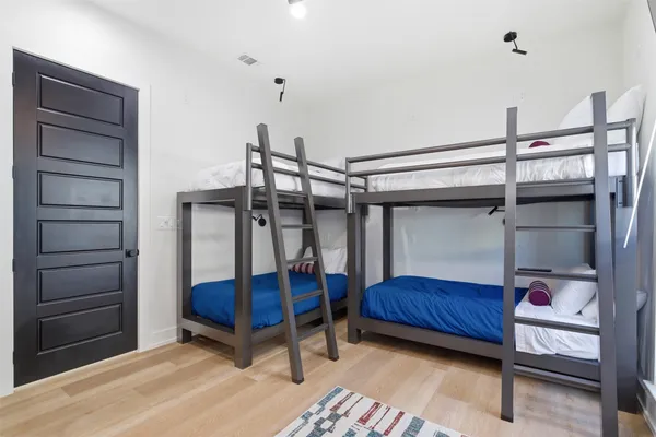 a bedroom with a bunk bed and a dresser