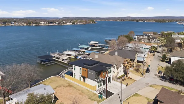 an aerial view of a house with lake view