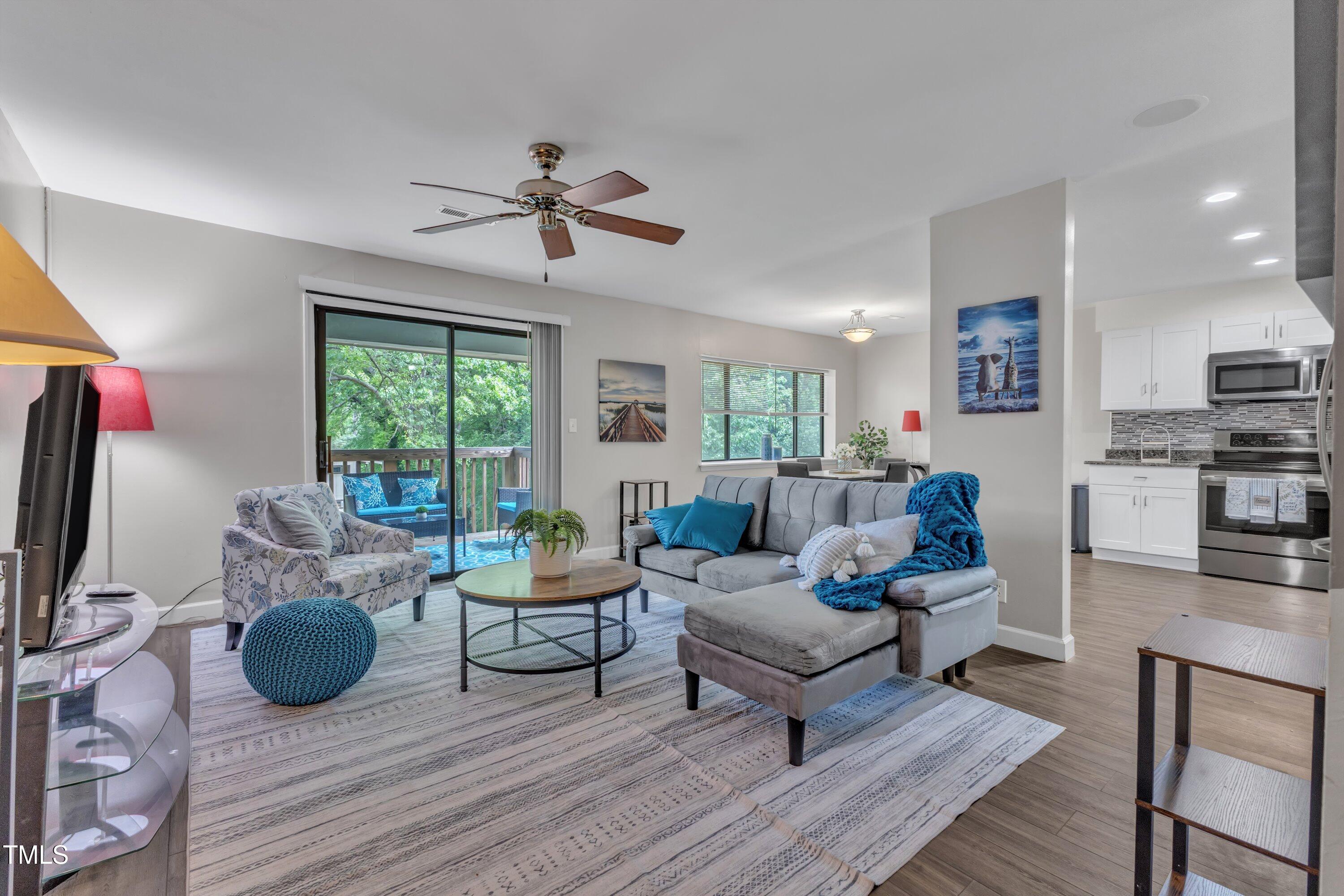 a living room with furniture a flat screen tv and a fireplace