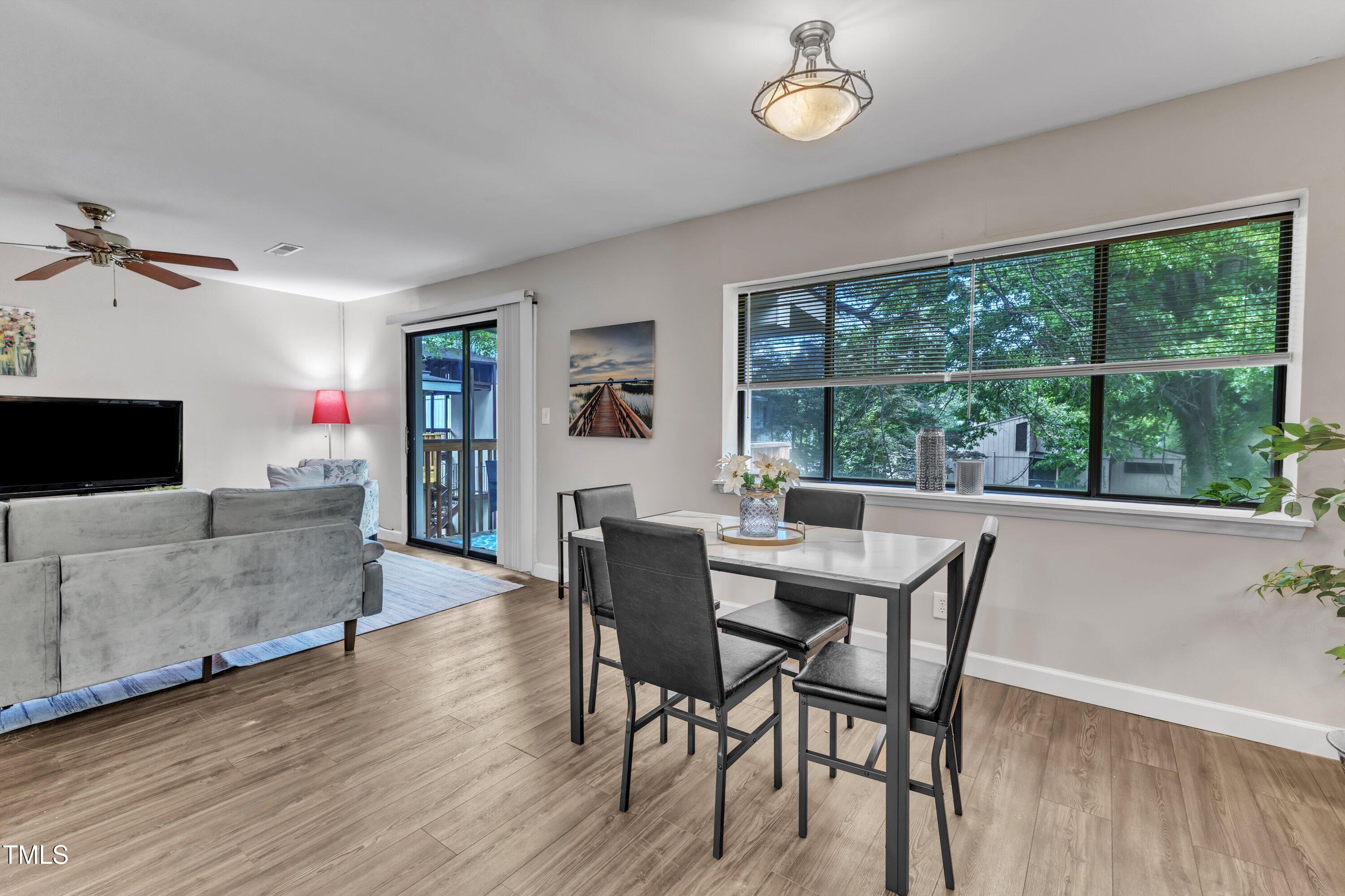 5022 Flint Ridge Place Raleigh, NC 27609 - Photo 12 of 32 a view of a dining room with furniture window and wooden floor