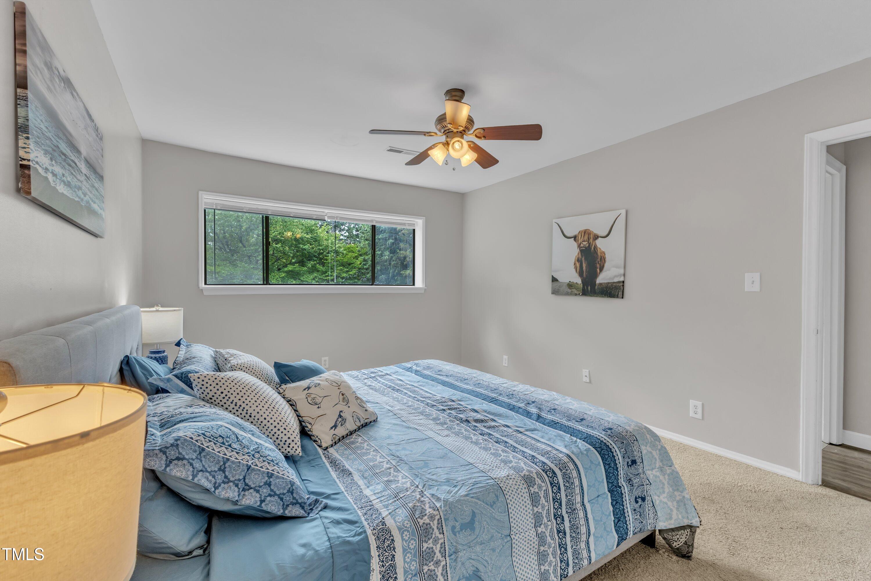 5022 Flint Ridge Place Raleigh, NC 27609 - Photo 18 of 32 a bedroom with a bed furniture and a window
