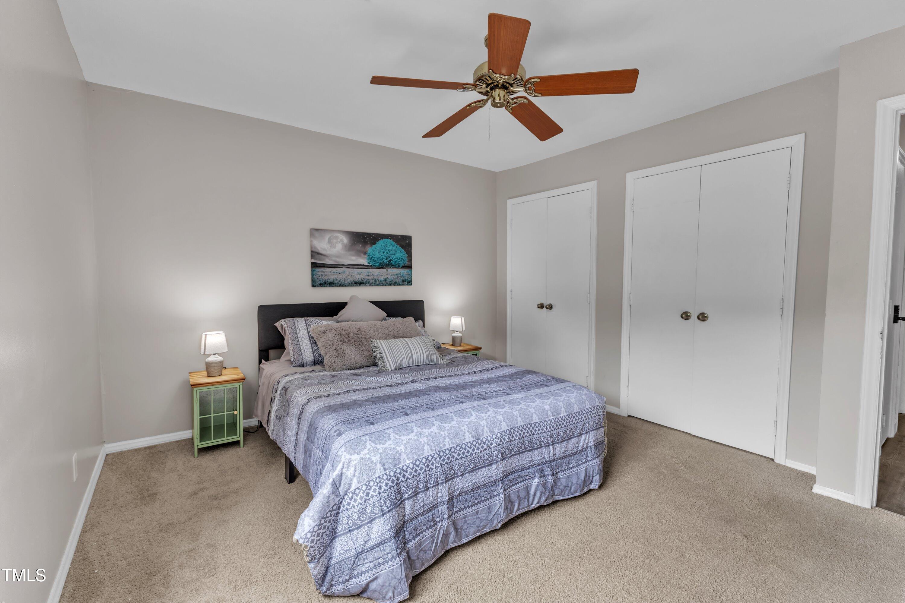 5022 Flint Ridge Place Raleigh, NC 27609 - Photo 20 of 32 a bedroom with a bed and a ceiling fan