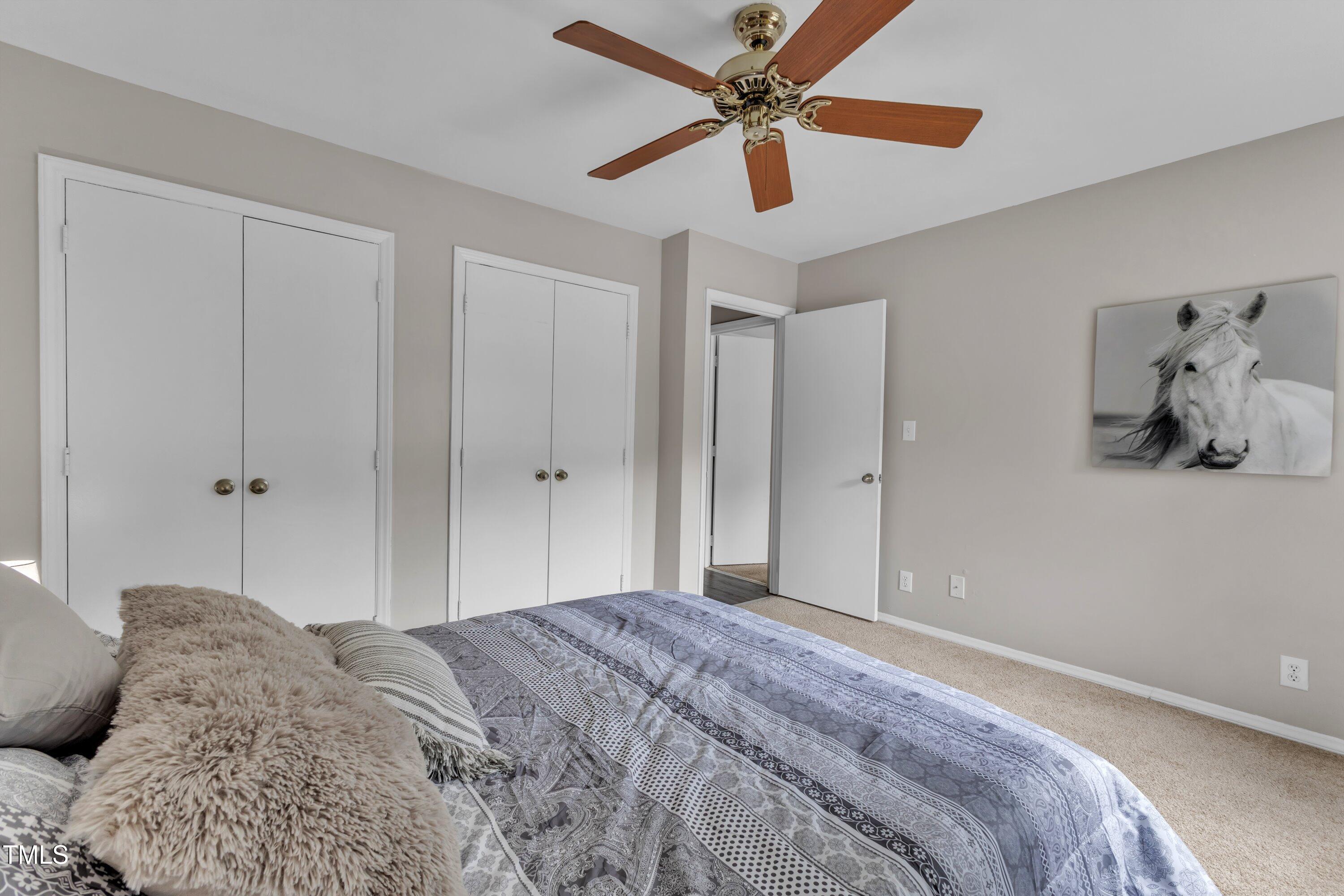 5022 Flint Ridge Place Raleigh, NC 27609 - Photo 21 of 32 a bedroom with a large bed and a chandelier