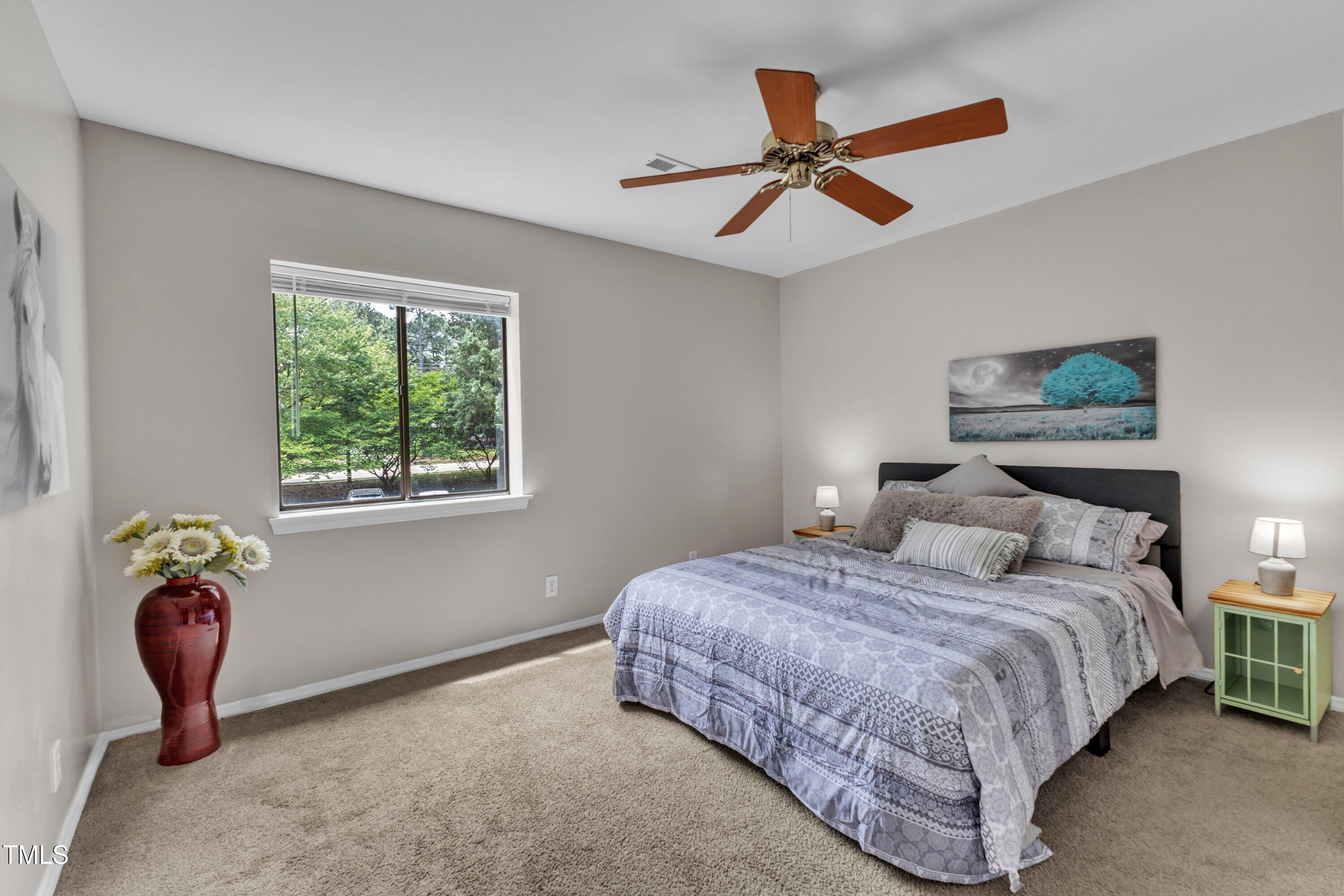 5022 Flint Ridge Place Raleigh, NC 27609 - Photo 26 of 32 a bedroom with a bed and a chandelier