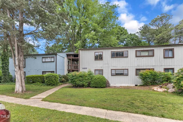a view of a house with a yard and plants