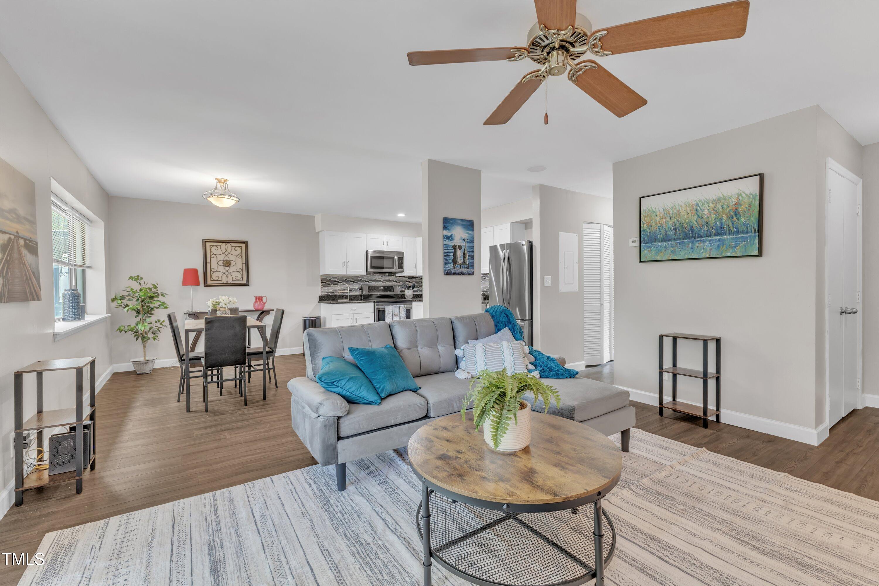 5022 Flint Ridge Place Raleigh, NC 27609 - Photo 4 of 32 a living room with furniture kitchen view and a wooden floor