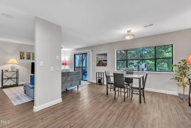 a view of a dining room with furniture and wooden floor