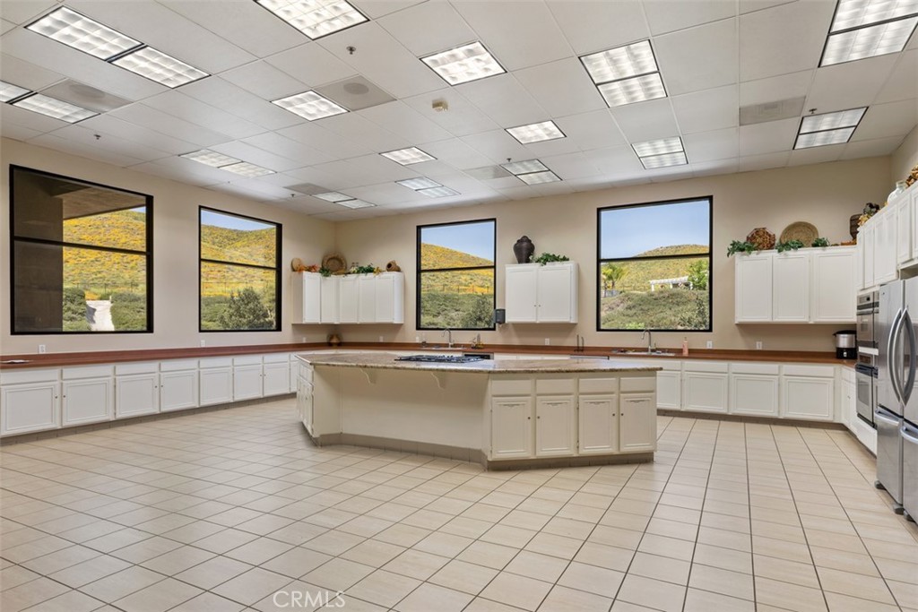 28208 Meadowsweet Drive Menifee, CA 92584 - Photo 44 of 55 a large white kitchen with a large window