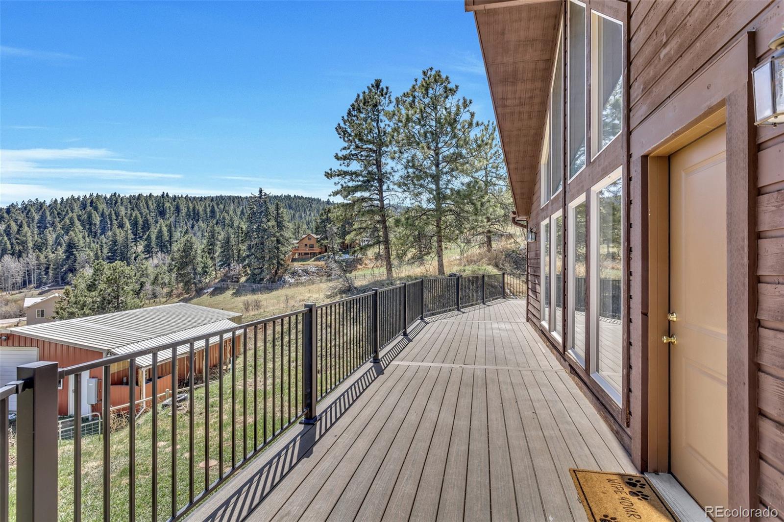 12183 Arnett Ranch Road Littleton, CO 80127 - Photo 22 of 28 a view of a balcony with wooden floor and fence