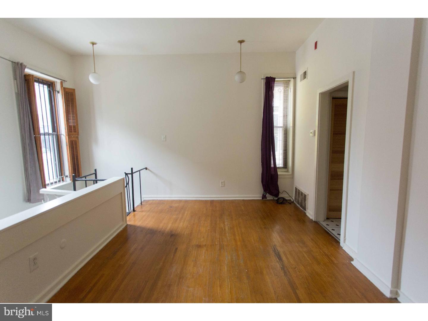 407 South 11th Street, Unit 3F Philadelphia, PA 19147 - Photo 12 of 14 a view of an empty room with window and wooden floor