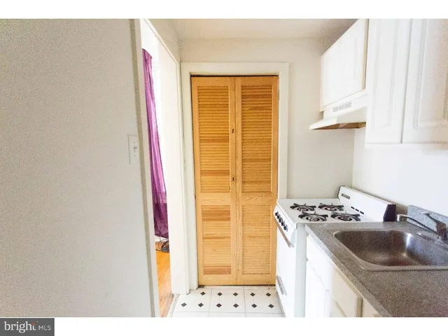 a kitchen with stainless steel appliances a stove a refrigerator and cabinets