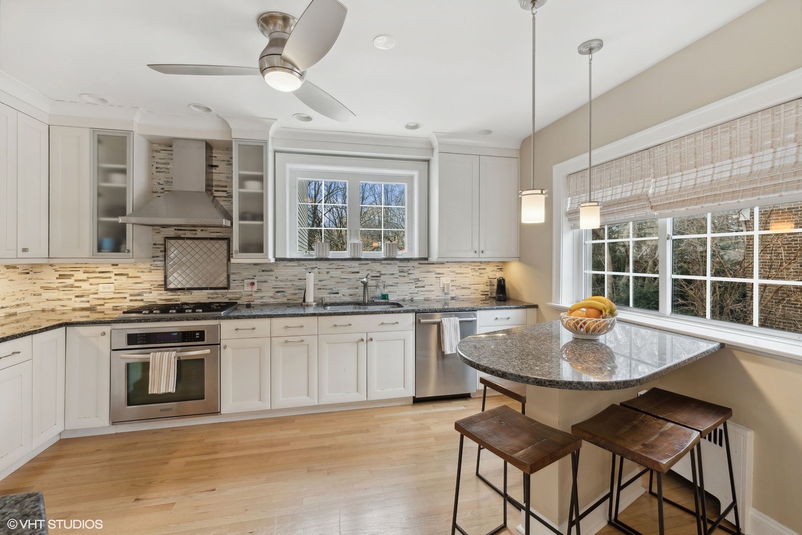 482 Uvedale Road Riverside, IL 60546 - Photo 5 of 29 a kitchen with a dining table cabinets and stainless steel appliances