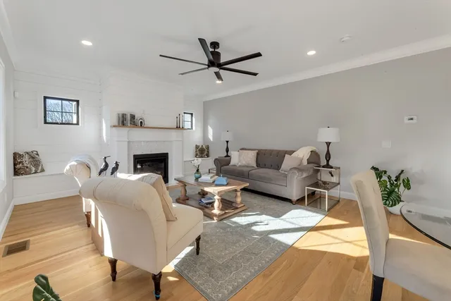 an empty room with windows and fireplace