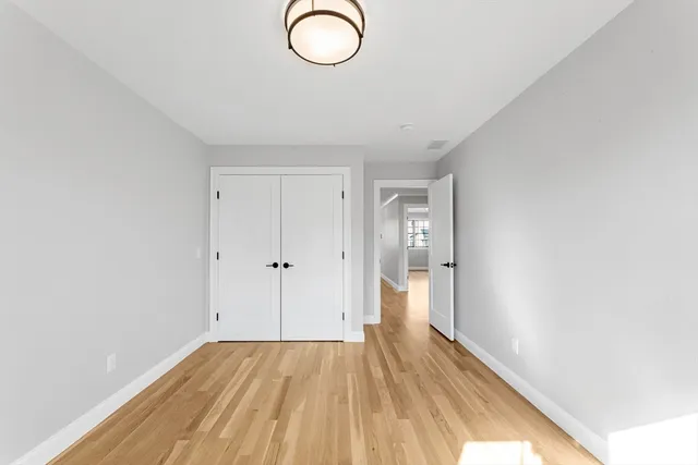 a view of room with wooden floor and window