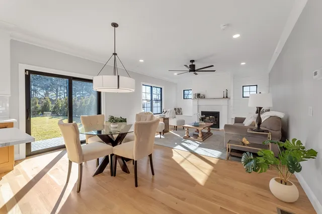 a living room with furniture a fireplace and a chandelier