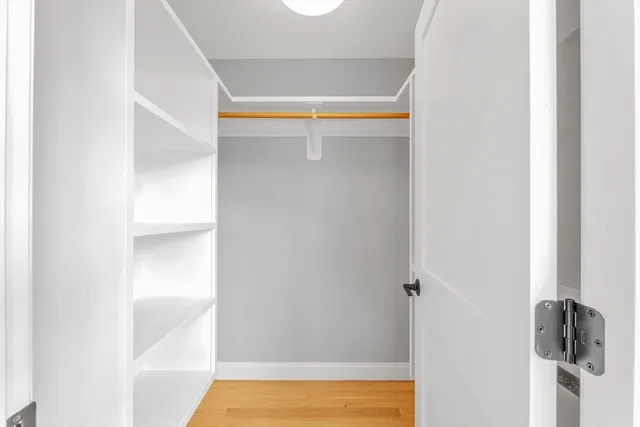 a view of walk in closet with empty racks