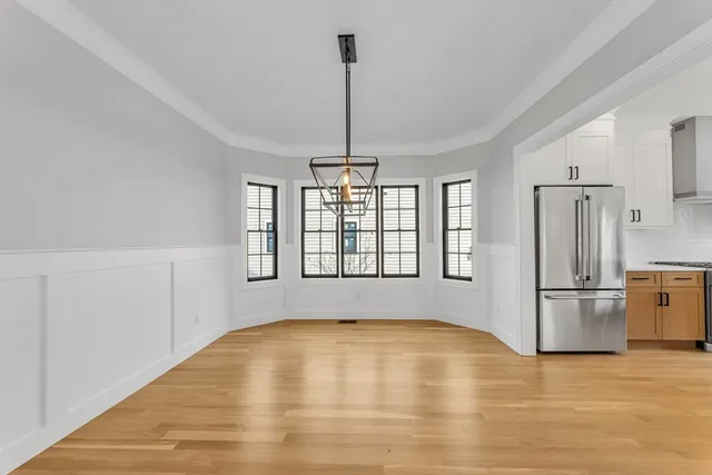 a view of empty room with wooden floor and outdoor view