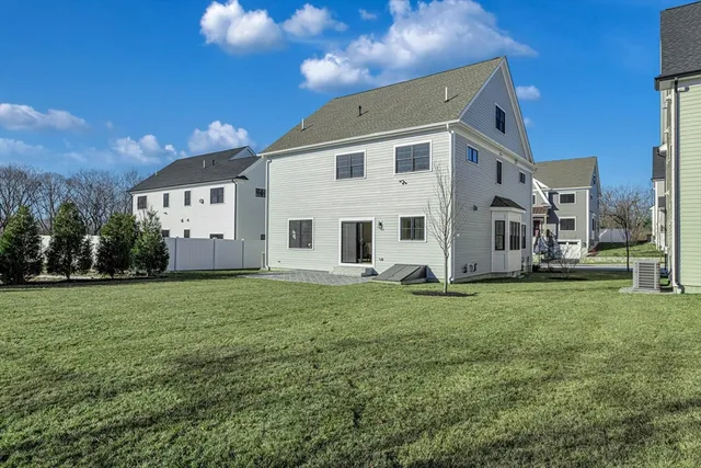 a living room with furniture kitchen view and a large window