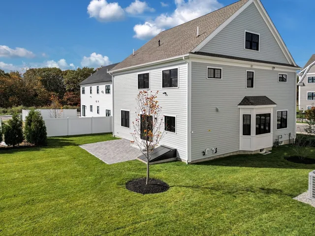 a view of a white house with a yard in front of it