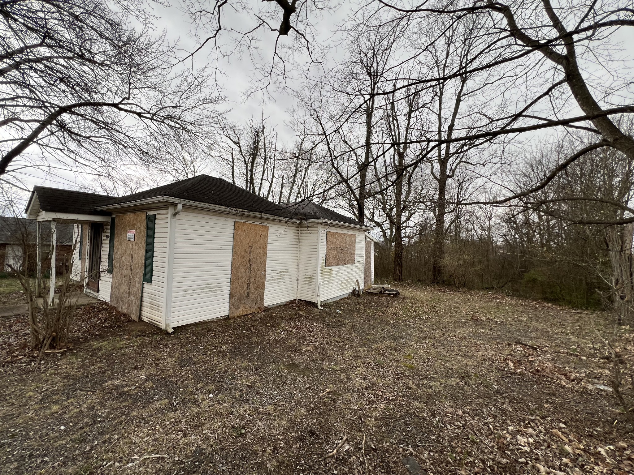 896 Peachers Mill Road Clarksville, TN 37042 - Photo 3 of 7 a white house that has a tree in front of it