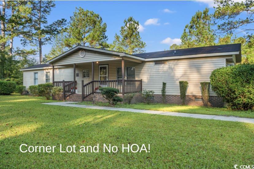 149 William Street Loris, SC 29569 - Photo 2 of 40 View of front of home with covered porch and a front yard