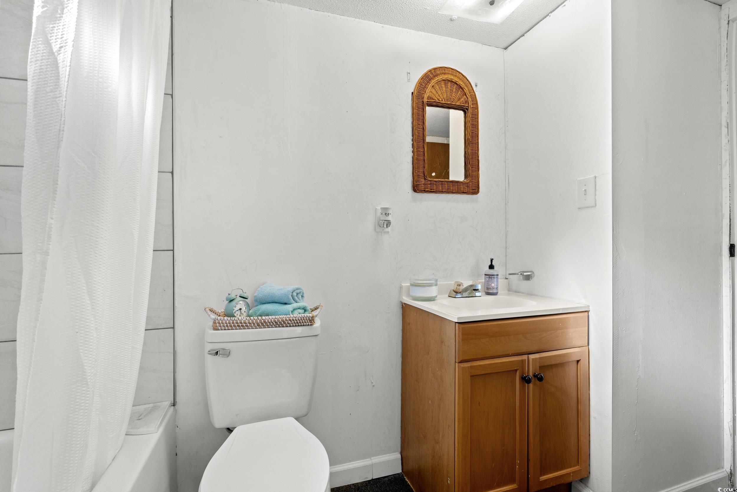 149 William Street Loris, SC 29569 - Photo 26 of 40 Bathroom with shower / tub combo and vanity