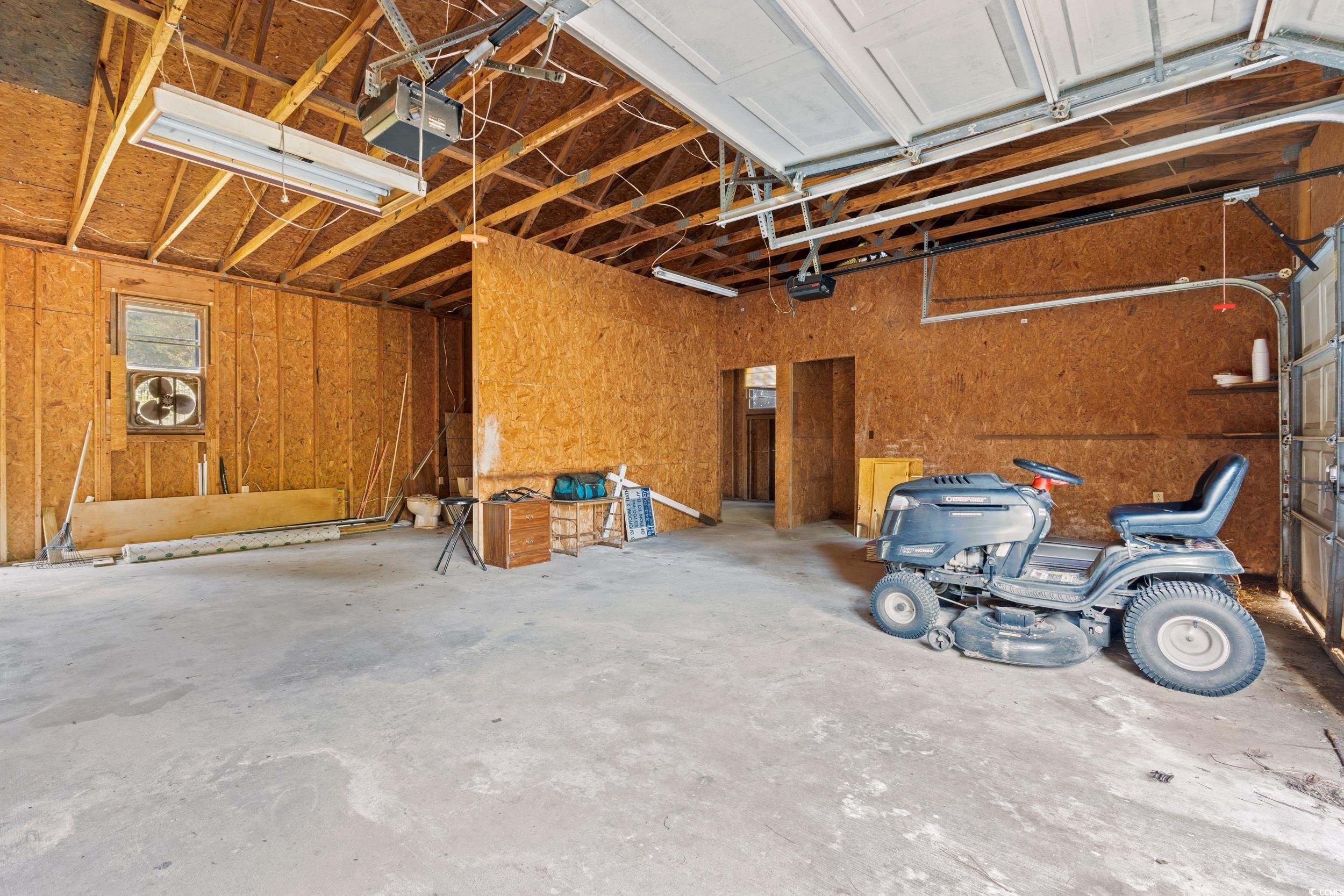 149 William Street Loris, SC 29569 - Photo 31 of 40 Garage featuring a garage door opener