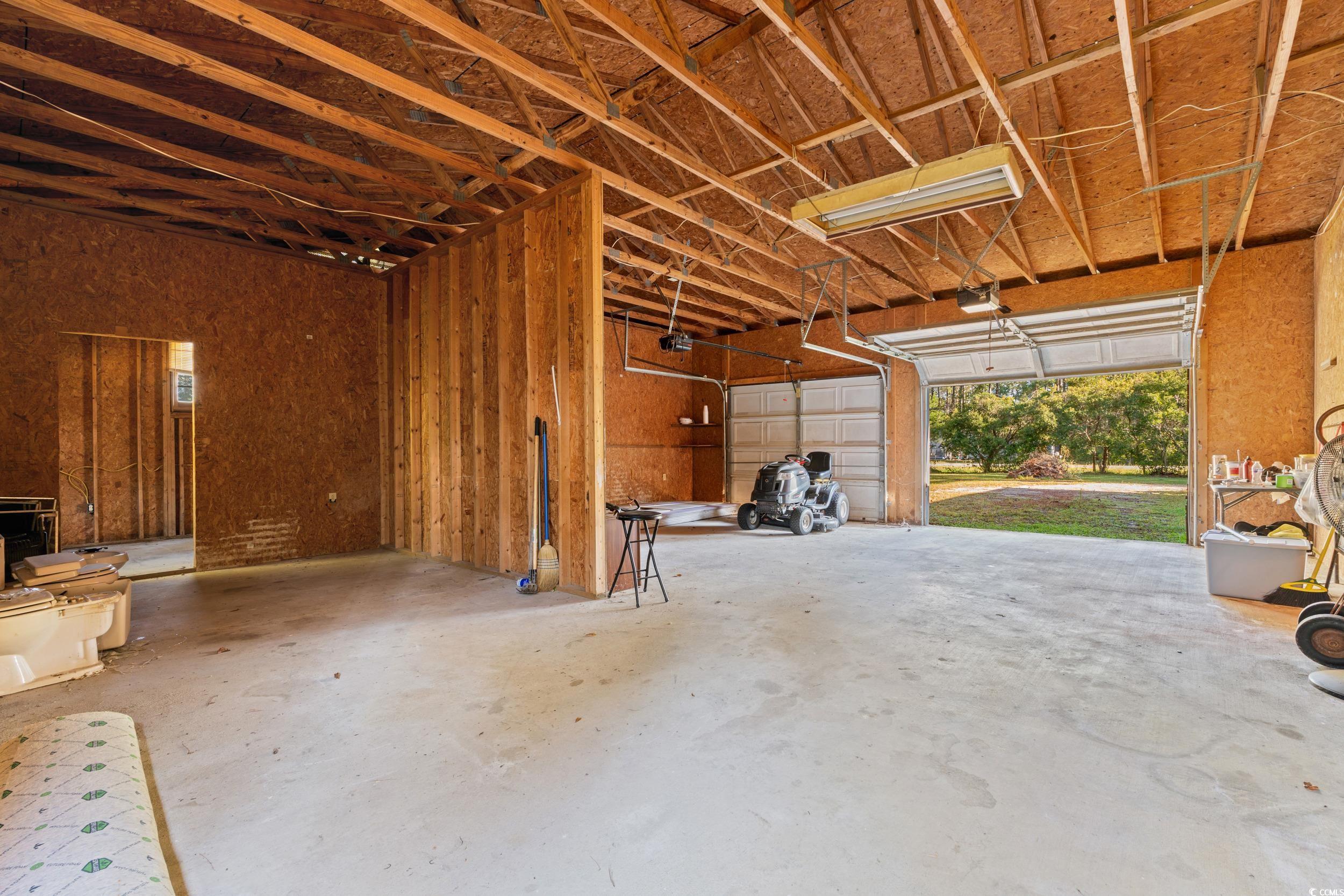 149 William Street Loris, SC 29569 - Photo 4 of 40 Garage with a garage door opener