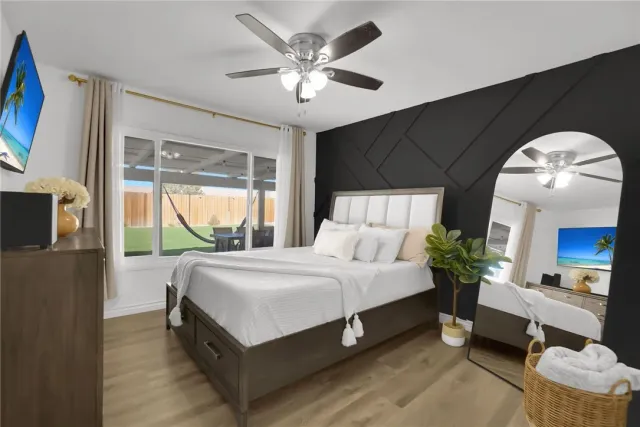 a spacious bedroom with a bed and a large window