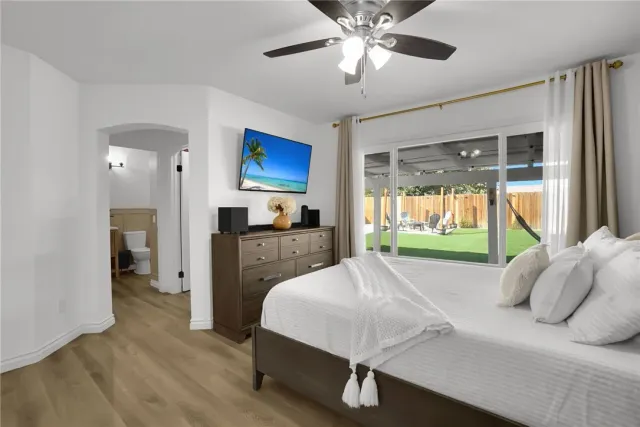 a bed room with a bed and a television