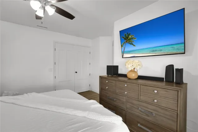 a bedroom with a bed and a flat screen tv