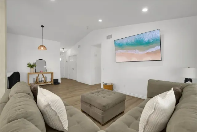 a living room with furniture and a chandelier