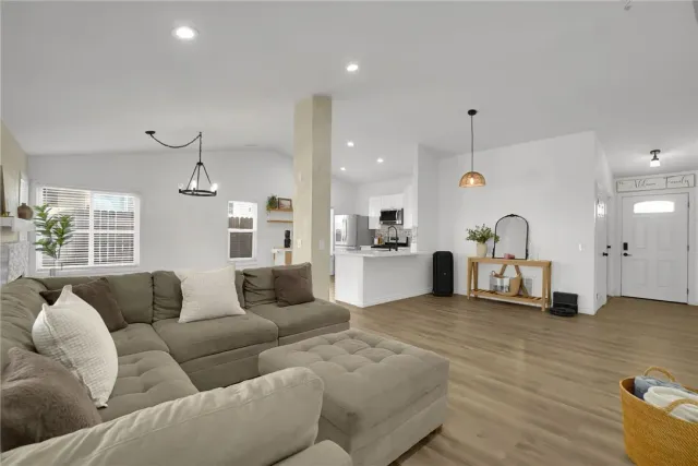 a living room with furniture and kitchen view