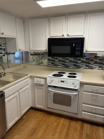 a kitchen with granite countertop a stove and a sink