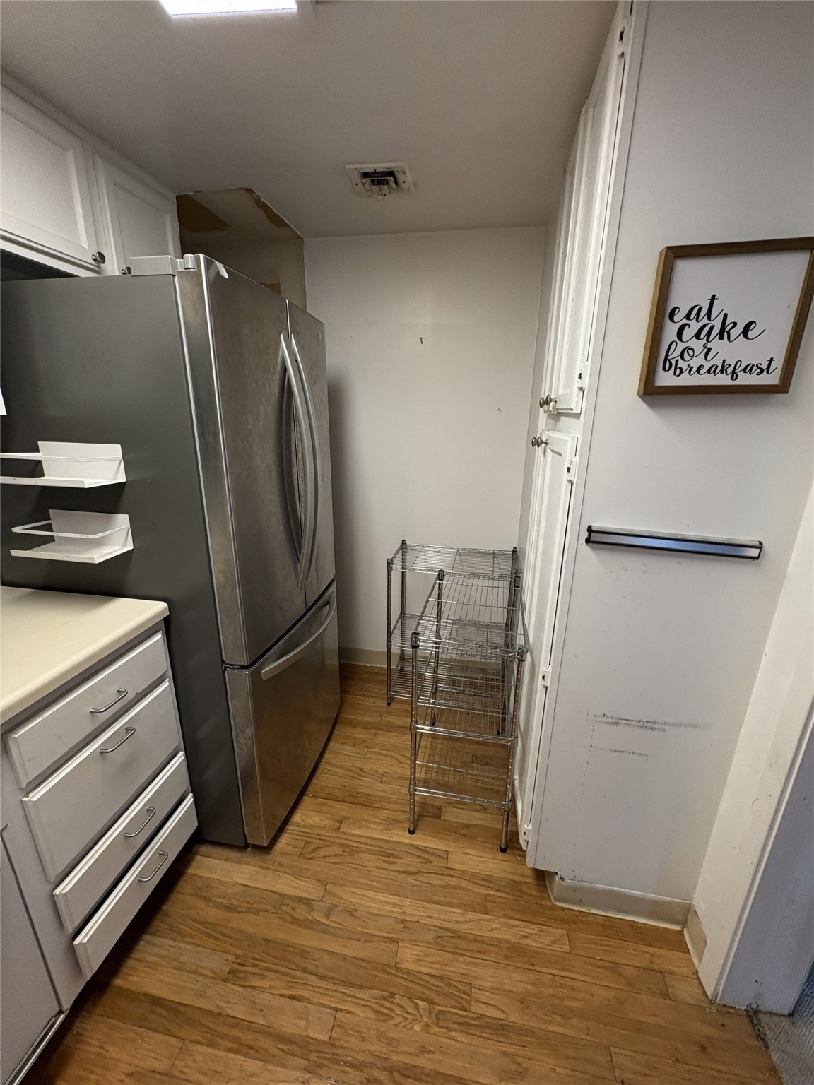 2016 Main Street, Unit 1620 Houston, TX 77002 - Photo 6 of 12 a view of a refrigerator in kitchen and an empty room