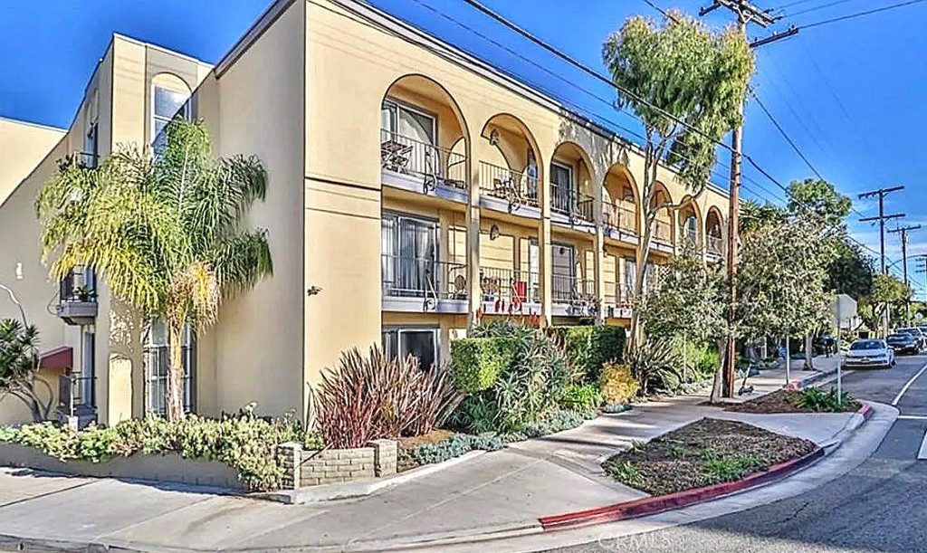 a view of a building with a potted plant and pathway
