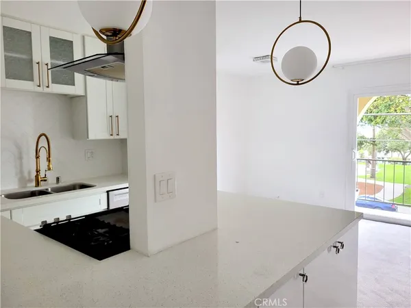 a kitchen with a sink and a stove