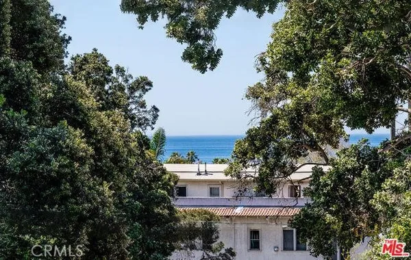 a view of a large building with a tree