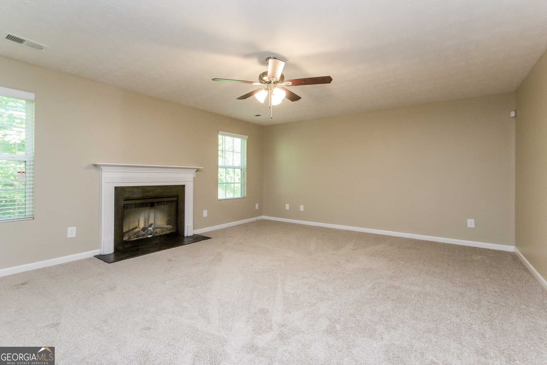 7287 Walton Hill Fairburn, GA 30213 - Photo 2 of 15 a view of an empty room with window and fireplace