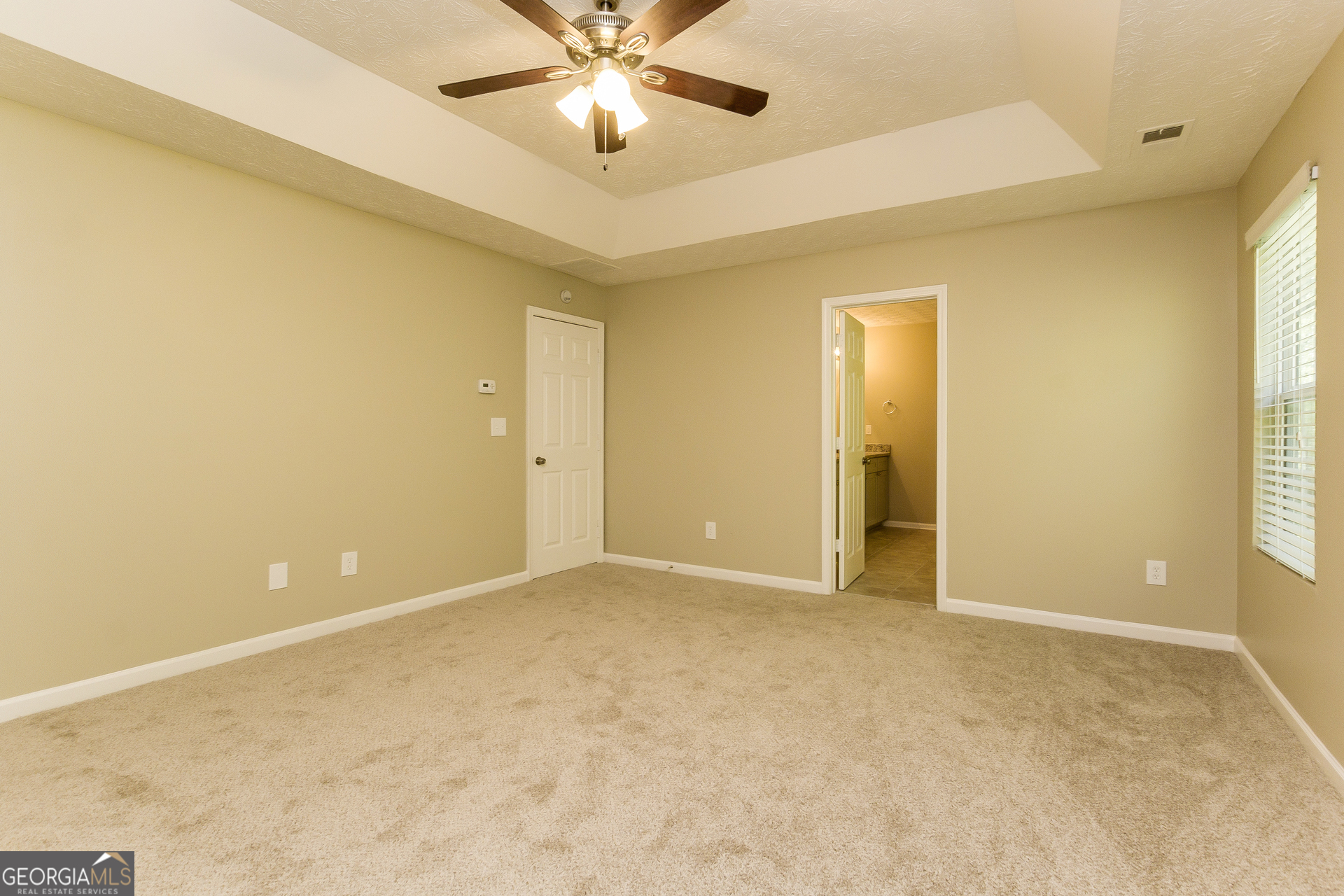 7287 Walton Hill Fairburn, GA 30213 - Photo 7 of 15 an empty room with a ceiling fan and a window