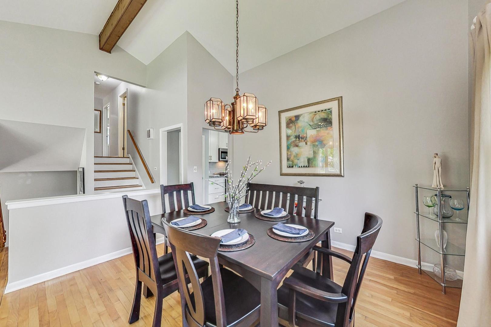 910 Whitegate Drive Mount Prospect, IL 60056 - Photo 11 of 38 a dining room with furniture a chandelier and wooden floor