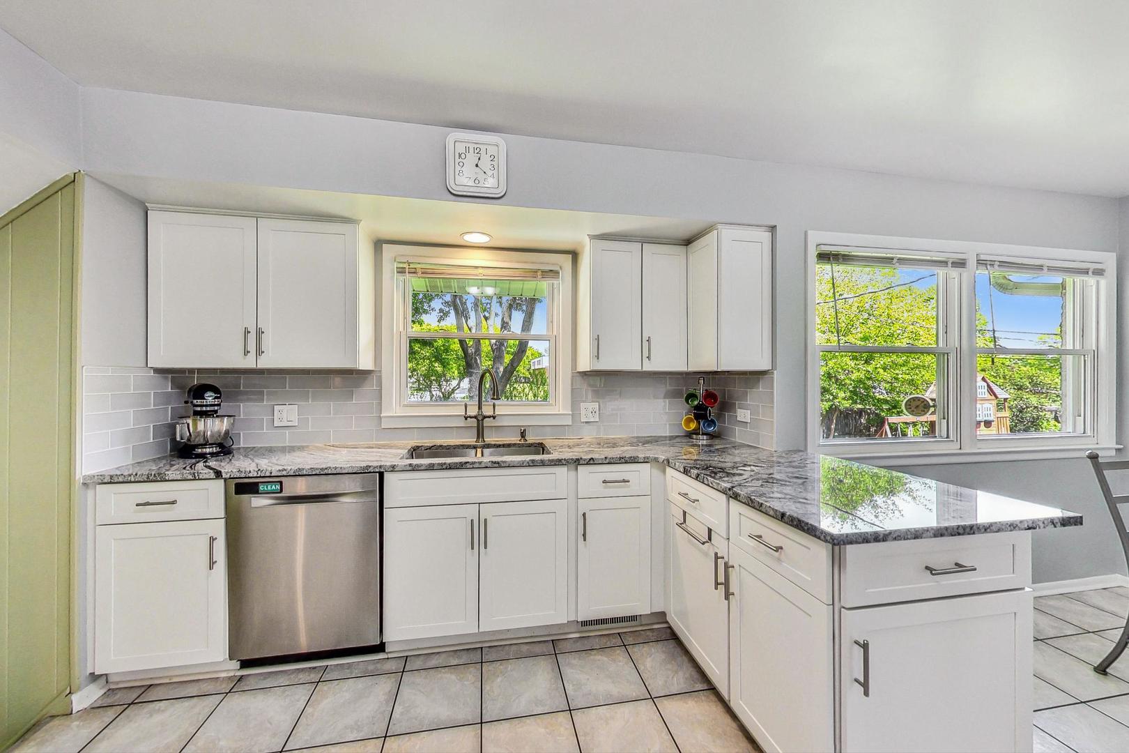 910 Whitegate Drive Mount Prospect, IL 60056 - Photo 12 of 38 a kitchen with a sink stove and cabinets