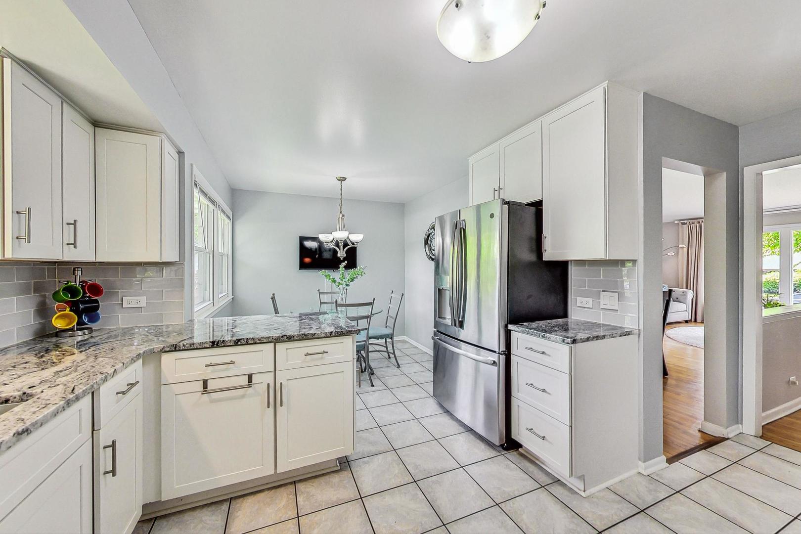 910 Whitegate Drive Mount Prospect, IL 60056 - Photo 13 of 38 a kitchen with white cabinets appliances and sink